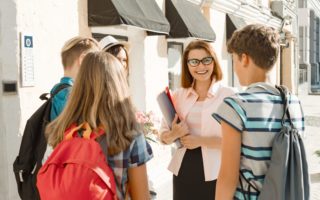 Outdoor school teacher with group of teenage high school students