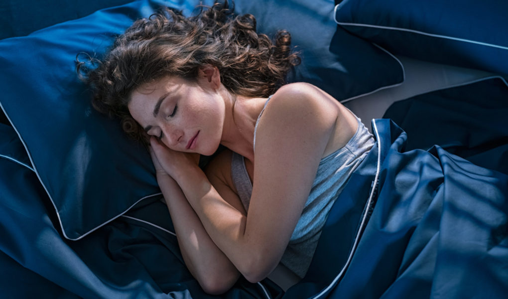 Young woman sleeping profoundly at night