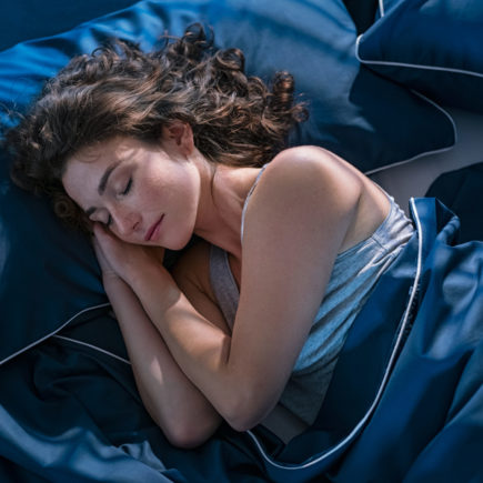 Young woman sleeping profoundly at night