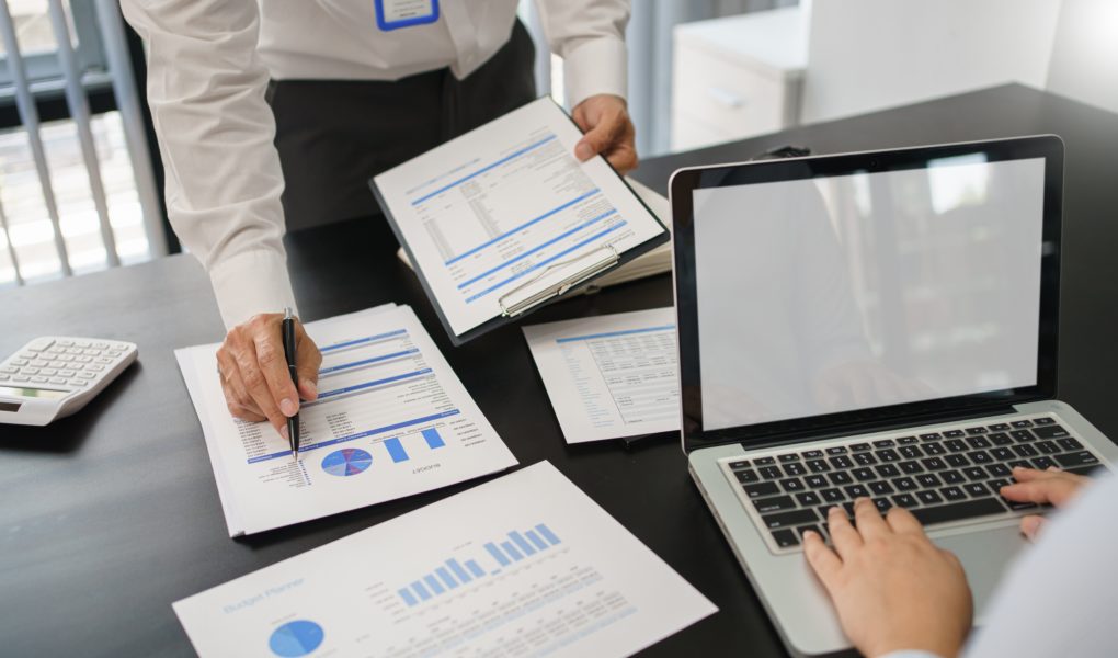 Business concept, Business man pointing on financial document to explaining information to partner.