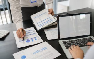 Business concept, Business man pointing on financial document to explaining information to partner.