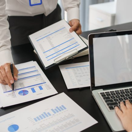 Business concept, Business man pointing on financial document to explaining information to partner.