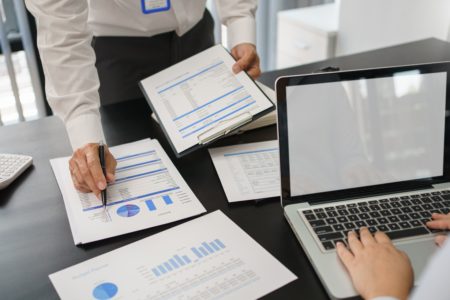 Business concept, Business man pointing on financial document to explaining information to partner.